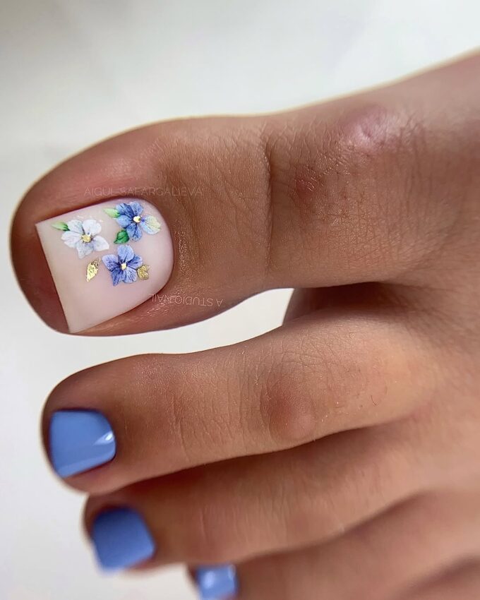 Pédicure blanche avec des hortensias bleus et des détails dorés